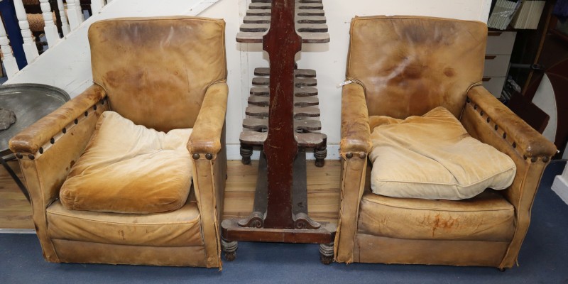 A pair of 1940s French tan leather club armchairs, W.77cm, D.74cm, H.84cm